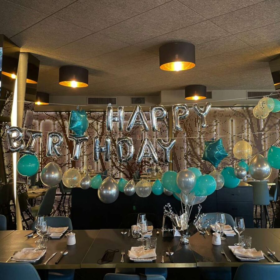 sala interna del ristorante addobbata per festa di compleanno con palloncini a tema